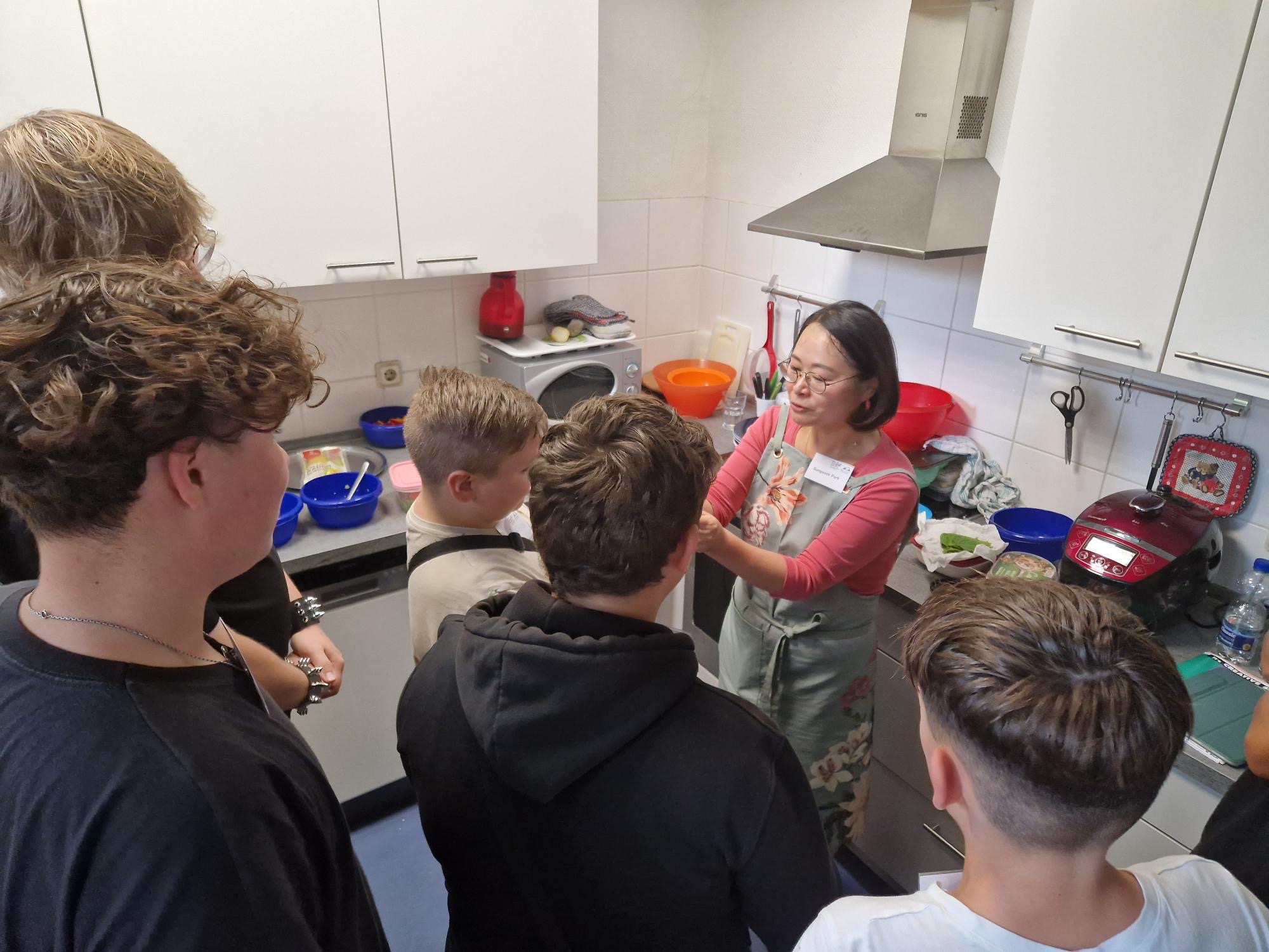 Young participants watch a cooking demonstration