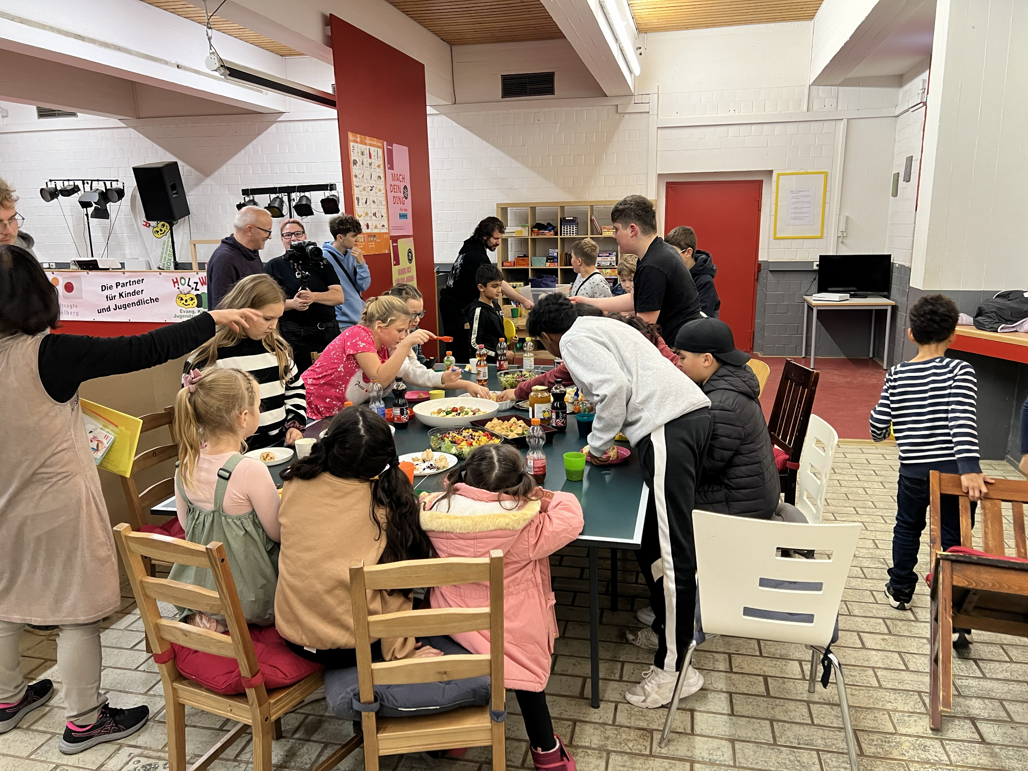 Children and teenagers share the Korean dishes they prepared together in the YEP workshop