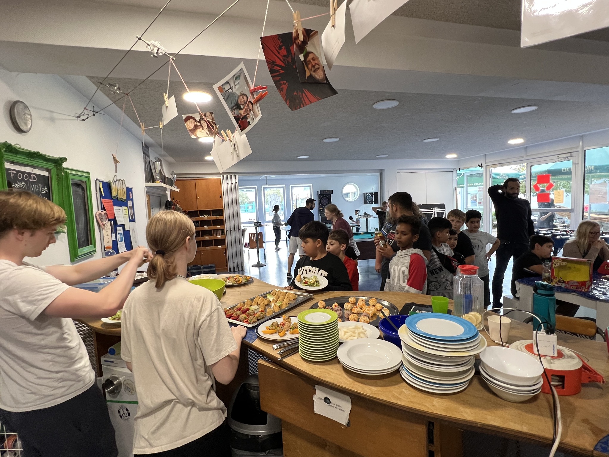 Children and teenagers gather around the food they prepared